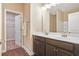 Bright bathroom features a double vanity with dark wood cabinets and a walk-in closet at 2147 Red Oak Cir, Union City, GA 30291