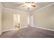 Spacious main bedroom with neutral carpet, ceiling fan and en suite bath at 2147 Red Oak Cir, Union City, GA 30291