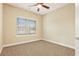 This bedroom is well-lit and has a ceiling fan and carpeted floor at 2147 Red Oak Cir, Union City, GA 30291