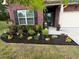 Charming brick home with manicured front yard and blooming flower beds at 2147 Red Oak Cir, Union City, GA 30291