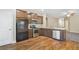 Stylish kitchen featuring stainless steel appliances, a tiled backsplash, and hardwood floors at 2147 Red Oak Cir, Union City, GA 30291