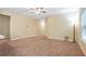 Expansive living room featuring neutral carpet, bright window light, and ceiling fan at 2147 Red Oak Cir, Union City, GA 30291