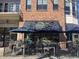 Inviting outdoor seating area at Verde Taqueria with shade umbrellas and iron railing at 2637 Mackintosh Ct # 8, Brookhaven, GA 30319