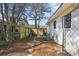 A side backyard view showcasing a fenced perimeter, landscaping, and a pathway leading to the house at 3180 Vine Cir, Decatur, GA 30033