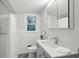 Clean bathroom featuring neutral tones, a single sink vanity, and a shower with white tile surround at 3180 Vine Cir, Decatur, GA 30033