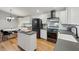 Bright kitchen featuring stainless steel appliances, an island and an adjacent dining area with a round table at 3180 Vine Cir, Decatur, GA 30033