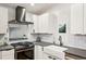 Modern kitchen featuring white cabinetry, subway tile backsplash, gray countertops and stainless steel appliances at 3180 Vine Cir, Decatur, GA 30033