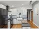 Modern kitchen with white cabinetry, hardwood flooring, stainless steel appliances, and a gray countertop island at 3180 Vine Cir, Decatur, GA 30033