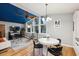 Cozy living room and eat-in kitchen featuring a unique blue ceiling, modern furniture, and hardwood floors at 3180 Vine Cir, Decatur, GA 30033