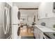 Modern kitchen featuring stainless steel appliances and a stacked washer/dryer for ultimate convenience at 343 8Th Street Ne # E2, Atlanta, GA 30309