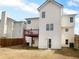 Back exterior view of home features a small deck and lawn at 4441 Prather Son Dr, Loganville, GA 30052