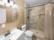 Bathroom with a shower featuring brown tiling, toilet, and single sink vanity at 4441 Prather Son Dr, Loganville, GA 30052