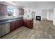 Well-lit kitchen featuring stainless steel dishwasher, dark countertops, and stylish pendant lights at 4441 Prather Son Dr, Loganville, GA 30052