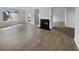 Spacious living room with modern floors and a cozy fireplace, great for entertaining and relaxation at 4441 Prather Son Dr, Loganville, GA 30052