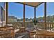 Cozy screened porch featuring comfortable seating and peaceful views of the surrounding trees at 545 Hanlon Way, Alpharetta, GA 30009