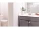 Well-lit bathroom with gray vanity, white countertop, decorative plant and view of shower at 1430 Baygreen Rd, Suwanee, GA 30024