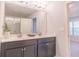 Bathroom featuring double sinks, a large mirror, and modern lighting fixtures at 1430 Baygreen Rd, Suwanee, GA 30024