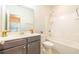 Well-lit bathroom with a gray vanity, white countertop, decorative plant, and a shower-tub combination at 1430 Baygreen Rd, Suwanee, GA 30024