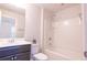 Well-lit bathroom with a dark vanity, white countertop, decorative plant, and a shower-tub combination at 1430 Baygreen Rd, Suwanee, GA 30024