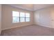 Spacious bedroom with carpet floors, large window, and a door at 1430 Baygreen Rd, Suwanee, GA 30024