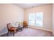 Cozy room featuring two chairs, a small table, a flower decoration, and a bright window at 1430 Baygreen Rd, Suwanee, GA 30024