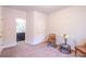 Bright room with view to bathroom, featuring two chairs, a small table, and white decorative flower arrangement at 1430 Baygreen Rd, Suwanee, GA 30024