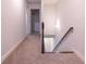 Upstairs hallway with carpet floors and a door to the laundry room and stairs to the third floor at 1430 Baygreen Rd, Suwanee, GA 30024