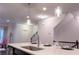 Bright kitchen island featuring a stainless steel sink and modern pendant lighting at 1430 Baygreen Rd, Suwanee, GA 30024