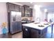 Kitchen island with white countertop and stainless steel appliances in a modern design at 1430 Baygreen Rd, Suwanee, GA 30024