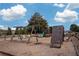 Community playground featuring swings, a slide, and a climbing wall under a partly cloudy sky at 1430 Baygreen Rd, Suwanee, GA 30024