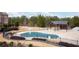 Community pool with a covered seating area, surrounded by well-maintained landscaping and fencing at 1430 Baygreen Rd, Suwanee, GA 30024