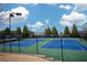 Well-maintained community tennis courts under a bright sky, surrounded by manicured landscaping at 1430 Baygreen Rd, Suwanee, GA 30024