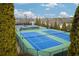 Aerial shot of multiple community tennis courts, framed by lush greenery and blue skies at 1430 Baygreen Rd, Suwanee, GA 30024