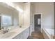 Bright bathroom with double vanity, large mirror, soaking tub, and seamless glass shower, great for relaxing at 1521 Reids Ferry Way, Marietta, GA 30062