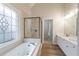 Luxurious bathroom with soaking tub, separate shower, dual vanities, and decorative leaded glass window at 1521 Reids Ferry Way, Marietta, GA 30062