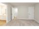 Bedroom featuring neutral carpet, walls, and white doors with en-suite bath at 1521 Reids Ferry Way, Marietta, GA 30062