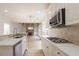 Stylish kitchen with white cabinets, quartz countertops, and stainless steel appliances overlooking the living area at 1521 Reids Ferry Way, Marietta, GA 30062