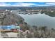 Aerial view of lakefront home near Bald Ridge Marina with mature trees and beautiful location at 4110 Sinclair Shores Rd, Cumming, GA 30041