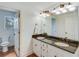 Bathroom featuring granite countertops, double sinks, and a view into the water closet at 4110 Sinclair Shores Rd, Cumming, GA 30041