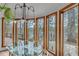 Dining area surrounded by large windows offering picturesque views of the water and trees at 4110 Sinclair Shores Rd, Cumming, GA 30041