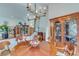 Elegant dining room featuring a wood table, display cabinet, and chandelier lighting at 4110 Sinclair Shores Rd, Cumming, GA 30041