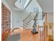 Foyer featuring curved staircase with black iron spindles and wooden floor at 4110 Sinclair Shores Rd, Cumming, GA 30041