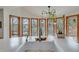 Kitchen sink with a view, framed by wood windows, overlooking a serene landscape at 4110 Sinclair Shores Rd, Cumming, GA 30041