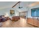 Spacious main bedroom with a ceiling fan, wood floors, and french doors to outside deck at 4110 Sinclair Shores Rd, Cumming, GA 30041