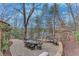 Paver patio featuring an outdoor dining table with seating for eight plus a stone fire pit at 4110 Sinclair Shores Rd, Cumming, GA 30041