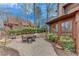 Paver patio and outdoor dining area surrounded by lush landscaping and mature trees at 4110 Sinclair Shores Rd, Cumming, GA 30041