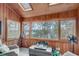 Sunroom with wood paneling, multiple windows, a view of a lake, and skylights at 4110 Sinclair Shores Rd, Cumming, GA 30041