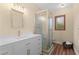 Bathroom featuring walk in shower, white vanity, and vinyl plank flooring at 4230 N Elizabeth Se Ln, Atlanta, GA 30339