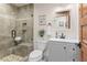 Stylish bathroom with glass shower, built in niches, stone seat and white vanity at 4230 N Elizabeth Se Ln, Atlanta, GA 30339