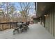 A deck with a gray surface has a table and chairs with views of the surrounding trees at 4230 N Elizabeth Se Ln, Atlanta, GA 30339